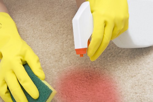Carpet cleaning staff following safety procedures in a work area