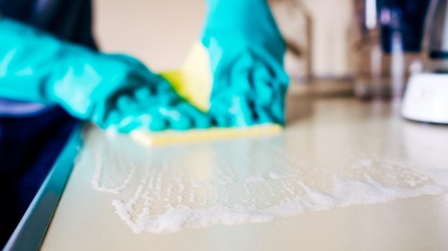 Technician handling cleaning machine safely during carpet cleaning